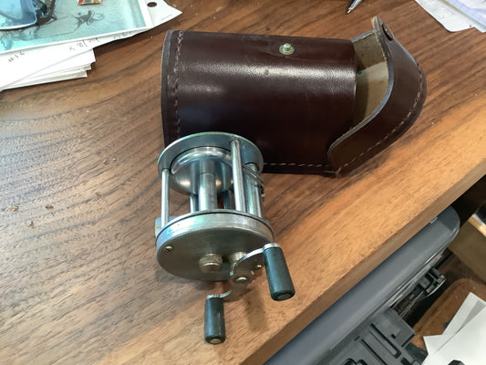J.A. Coxe - Bronson, Michigan fishing reel and leather case.