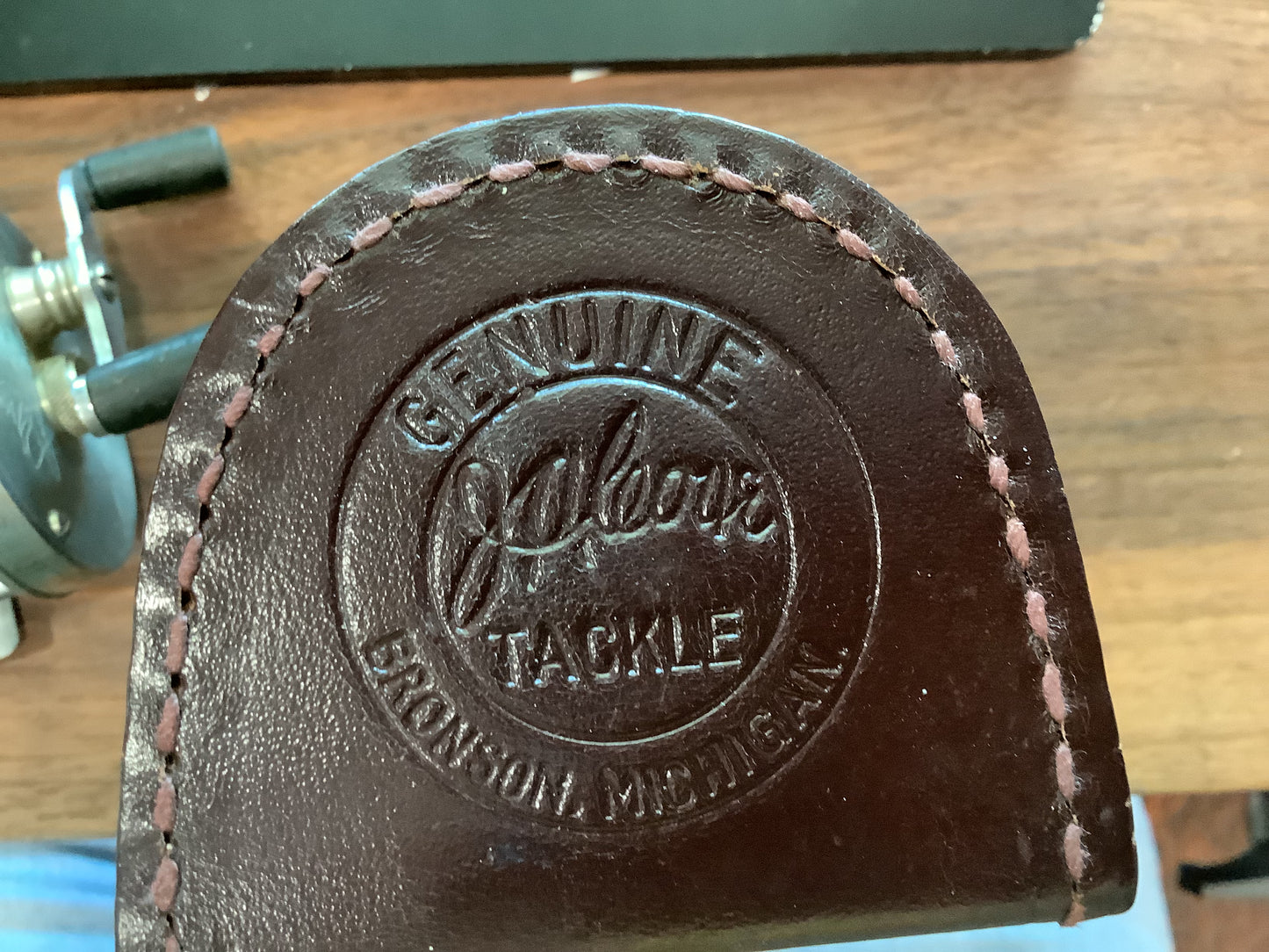 J.A. Coxe - Bronson, Michigan fishing reel and leather case.