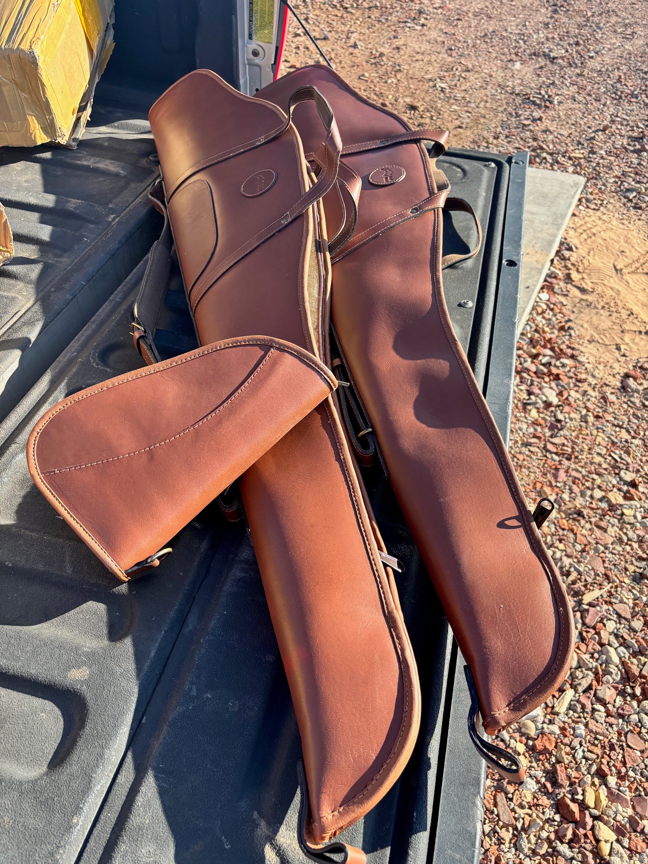 Custom Harness Leather shotgun and pistol cases plus shotgun shell carrier